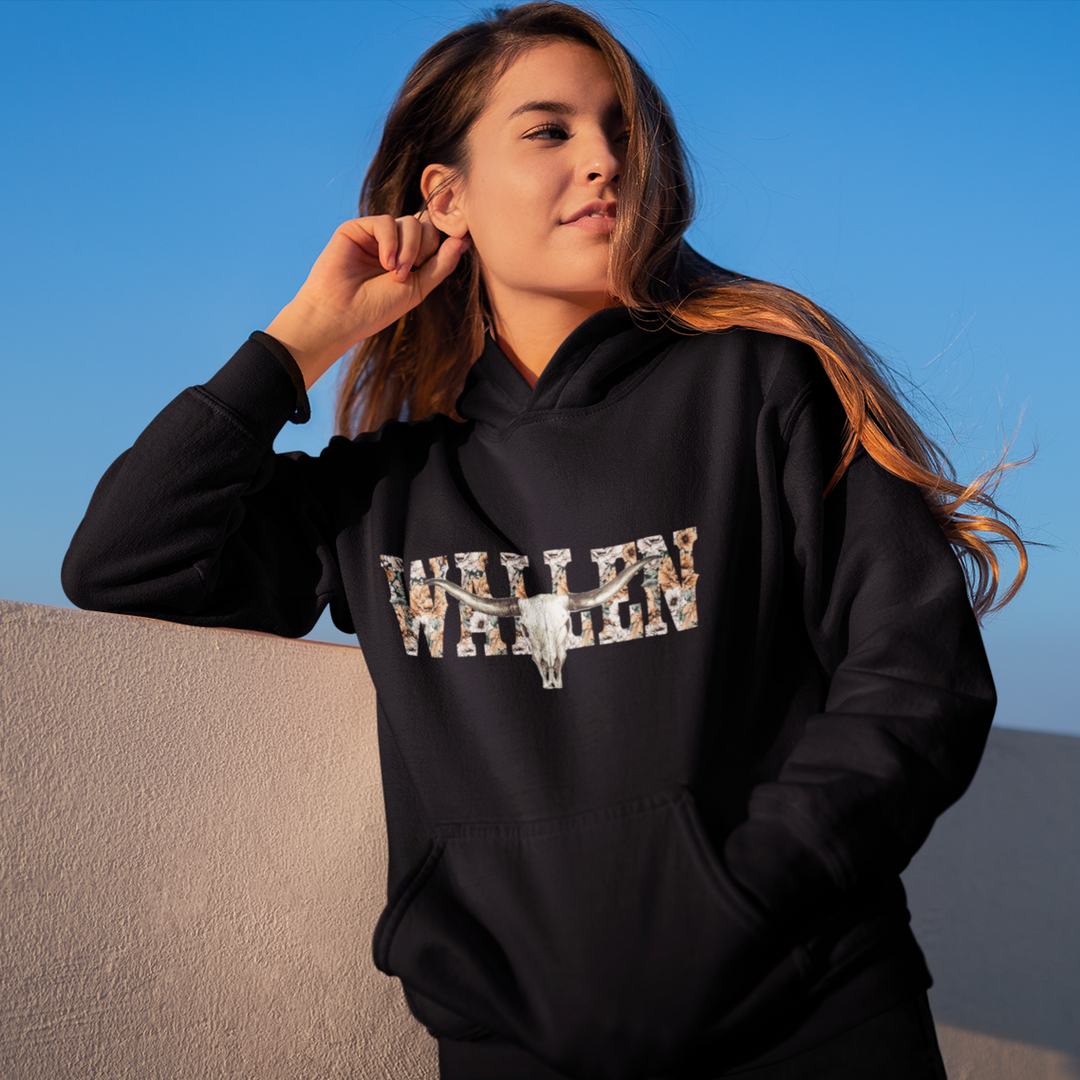 Woman in a black Hoodie with Wallen text flowers in the text and a bull skull