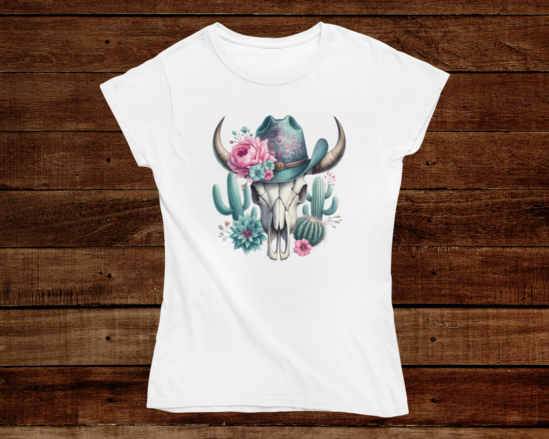 White t-shirt with a graphic design of a cow skull, flowers, and cacti on a wooden background